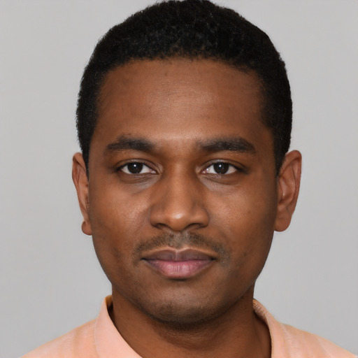 Joyful black young-adult male with short  black hair and brown eyes