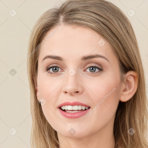 Joyful white young-adult female with long  brown hair and green eyes