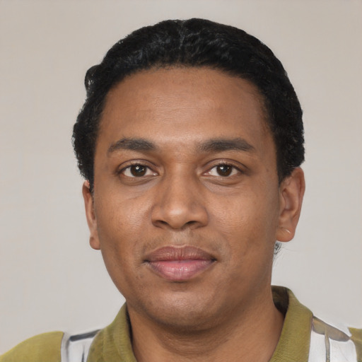 Joyful black young-adult male with short  black hair and brown eyes