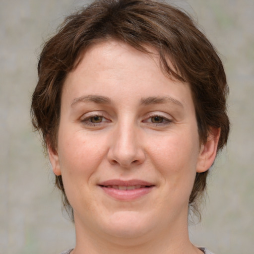 Joyful white young-adult female with medium  brown hair and green eyes