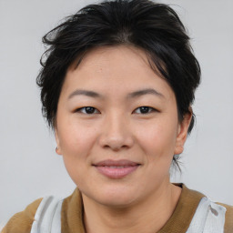 Joyful asian young-adult female with short  brown hair and brown eyes