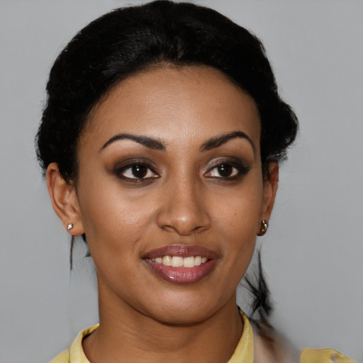 Joyful latino young-adult female with short  brown hair and brown eyes
