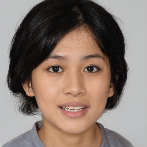 Joyful asian young-adult female with medium  black hair and brown eyes