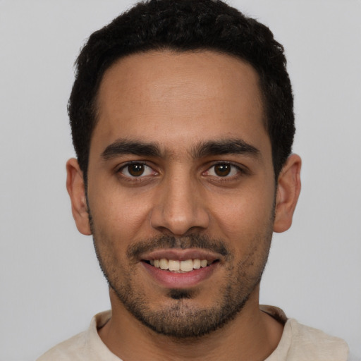 Joyful white young-adult male with short  black hair and brown eyes