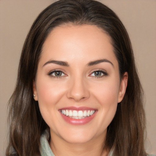 Joyful white young-adult female with long  brown hair and brown eyes