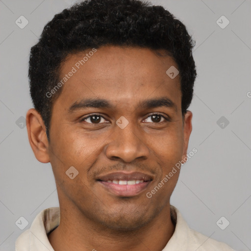 Joyful black young-adult male with short  black hair and brown eyes