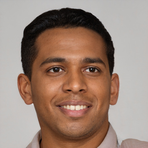 Joyful latino young-adult male with short  black hair and brown eyes