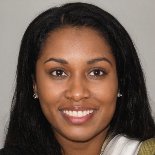 Joyful latino young-adult female with long  black hair and brown eyes