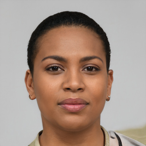 Joyful latino young-adult female with short  brown hair and brown eyes