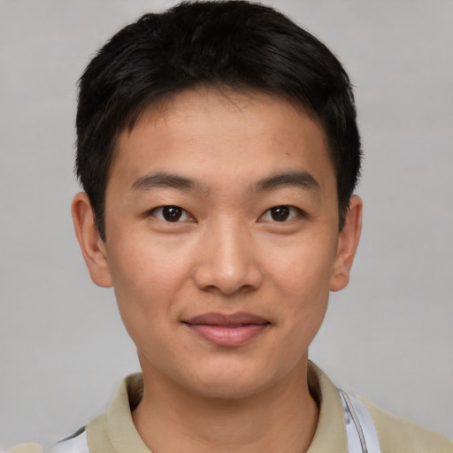 Joyful asian young-adult male with short  brown hair and brown eyes
