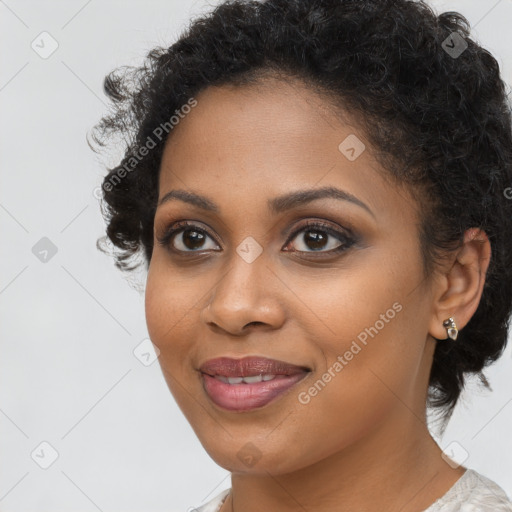 Joyful black young-adult female with long  brown hair and brown eyes