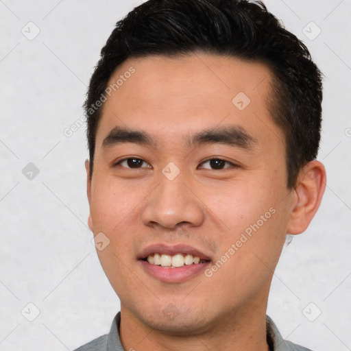 Joyful white young-adult male with short  black hair and brown eyes