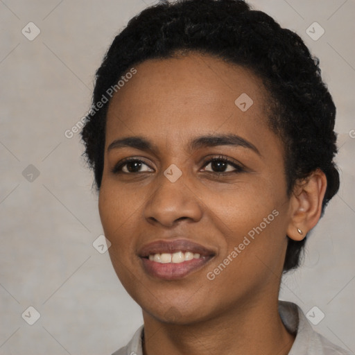 Joyful black young-adult female with short  black hair and brown eyes