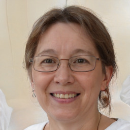 Joyful white adult female with medium  brown hair and brown eyes