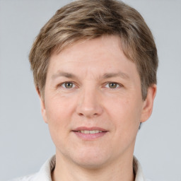 Joyful white adult male with short  brown hair and grey eyes