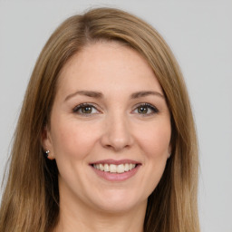 Joyful white young-adult female with long  brown hair and green eyes