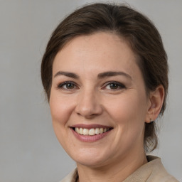 Joyful white young-adult female with medium  brown hair and brown eyes