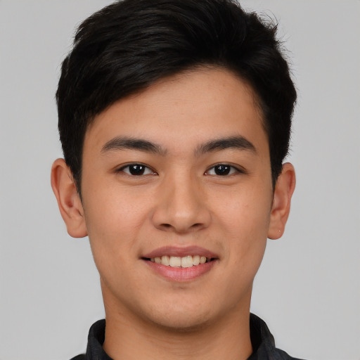 Joyful white young-adult male with short  black hair and brown eyes