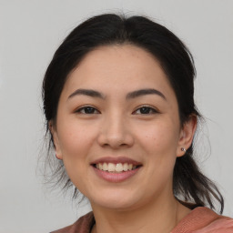 Joyful asian young-adult female with medium  brown hair and brown eyes