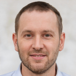 Joyful white adult male with short  brown hair and brown eyes