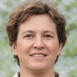 Joyful white adult female with short  brown hair and grey eyes