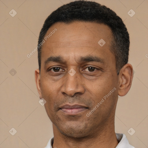Joyful latino adult male with short  black hair and brown eyes