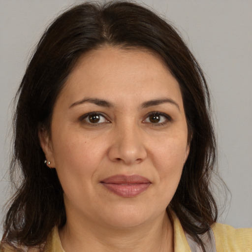 Joyful white adult female with medium  brown hair and brown eyes