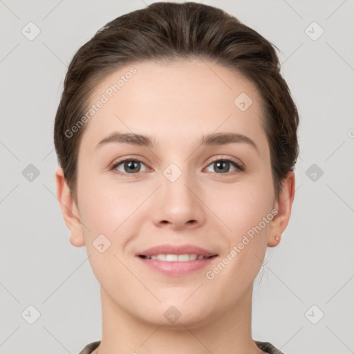 Joyful white young-adult female with short  brown hair and grey eyes