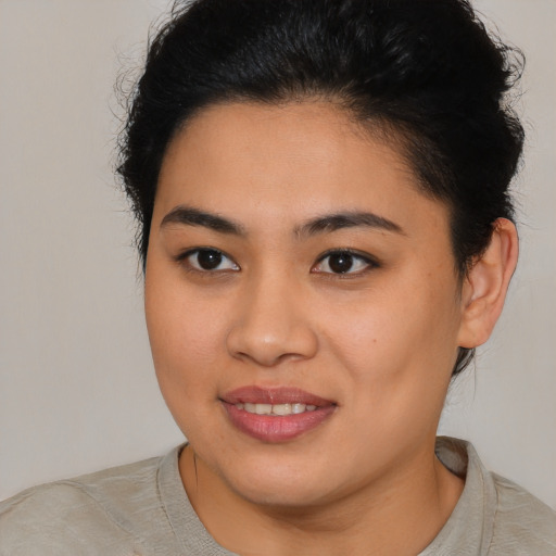 Joyful latino young-adult female with short  brown hair and brown eyes