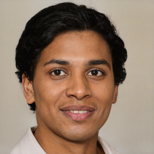 Joyful latino young-adult male with short  brown hair and brown eyes