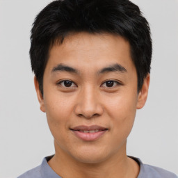 Joyful asian young-adult male with short  black hair and brown eyes