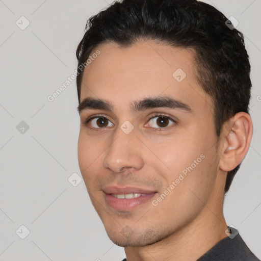 Joyful white young-adult male with short  black hair and brown eyes