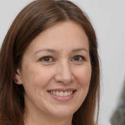 Joyful white adult female with long  brown hair and brown eyes