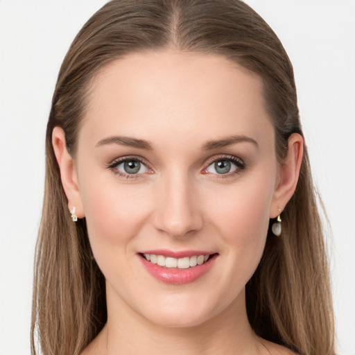 Joyful white young-adult female with long  brown hair and blue eyes