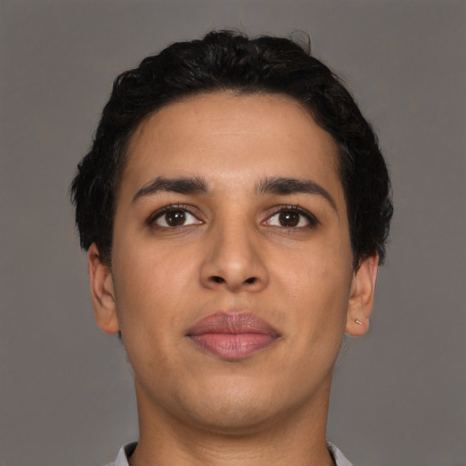 Joyful latino young-adult male with short  brown hair and brown eyes