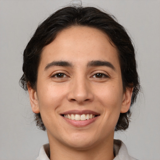 Joyful white young-adult female with medium  brown hair and brown eyes