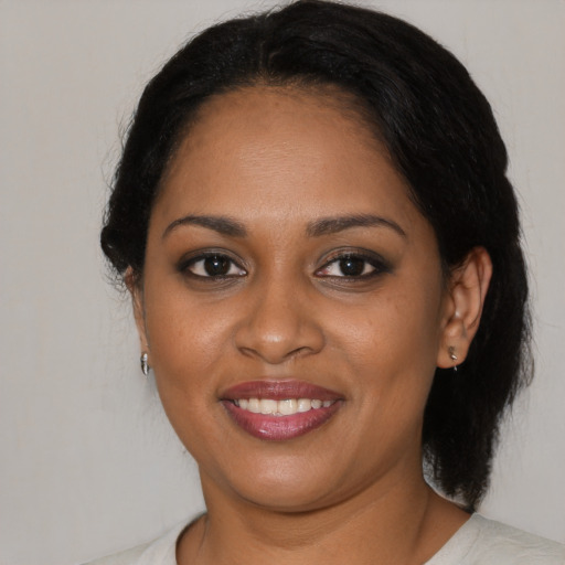 Joyful black young-adult female with medium  brown hair and brown eyes