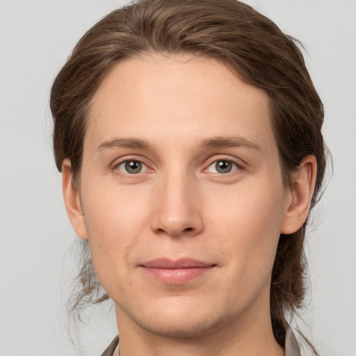 Joyful white young-adult female with medium  brown hair and grey eyes