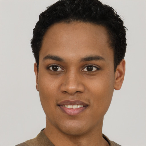 Joyful black young-adult female with short  black hair and brown eyes