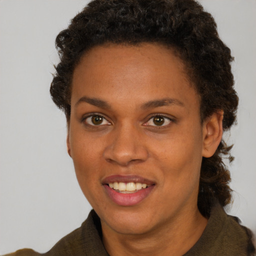 Joyful black young-adult female with short  brown hair and brown eyes
