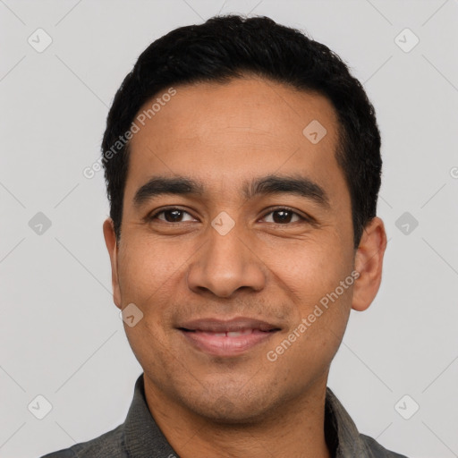 Joyful latino young-adult male with short  black hair and brown eyes