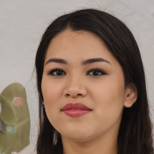 Joyful asian young-adult female with long  black hair and brown eyes