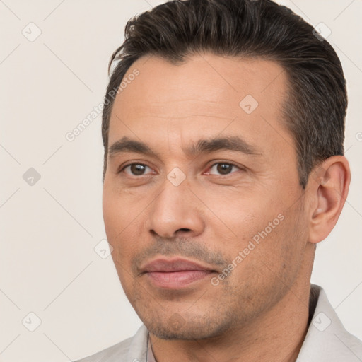 Joyful white young-adult male with short  black hair and brown eyes