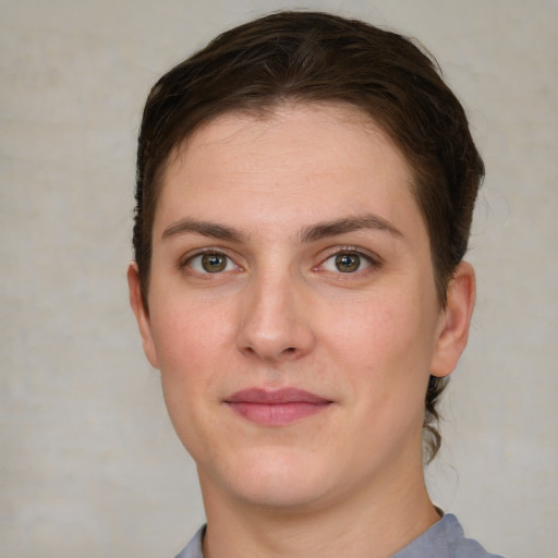 Joyful white young-adult female with short  brown hair and grey eyes