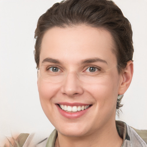 Joyful white young-adult female with short  brown hair and grey eyes