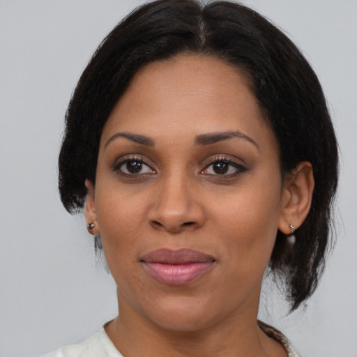Joyful latino young-adult female with medium  black hair and brown eyes