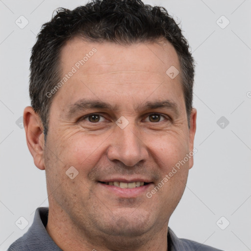 Joyful white adult male with short  brown hair and brown eyes