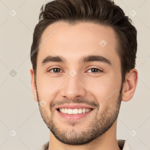 Joyful white young-adult male with short  brown hair and brown eyes