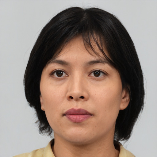 Neutral asian young-adult female with medium  brown hair and brown eyes
