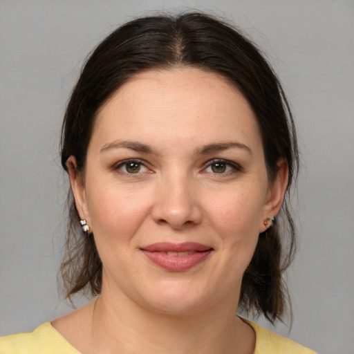 Joyful white adult female with medium  brown hair and brown eyes